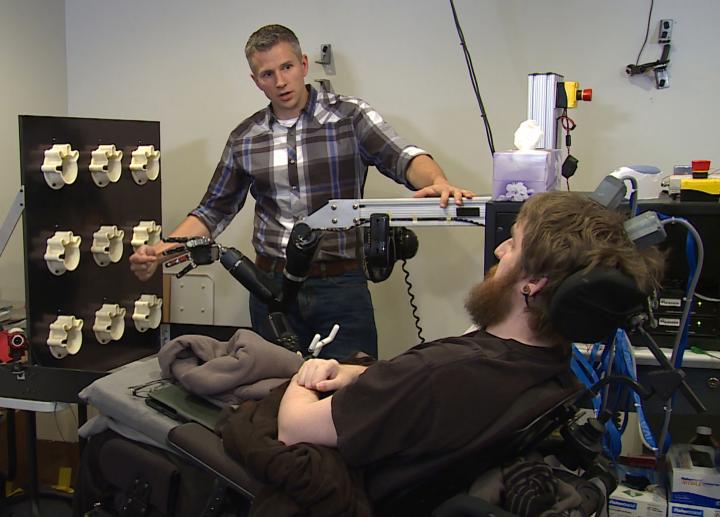 Researcher Rob Gaunt prepares Nathan Copeland for brain computer interface sensory test. This material relates to a paper that appeared in the 12 October 2016, issue of Science Translational Medicine, published by AAAS. The paper, by S.N. Flesher at University of Pittsburgh in Pittsburgh, PA, and colleagues was titled, 